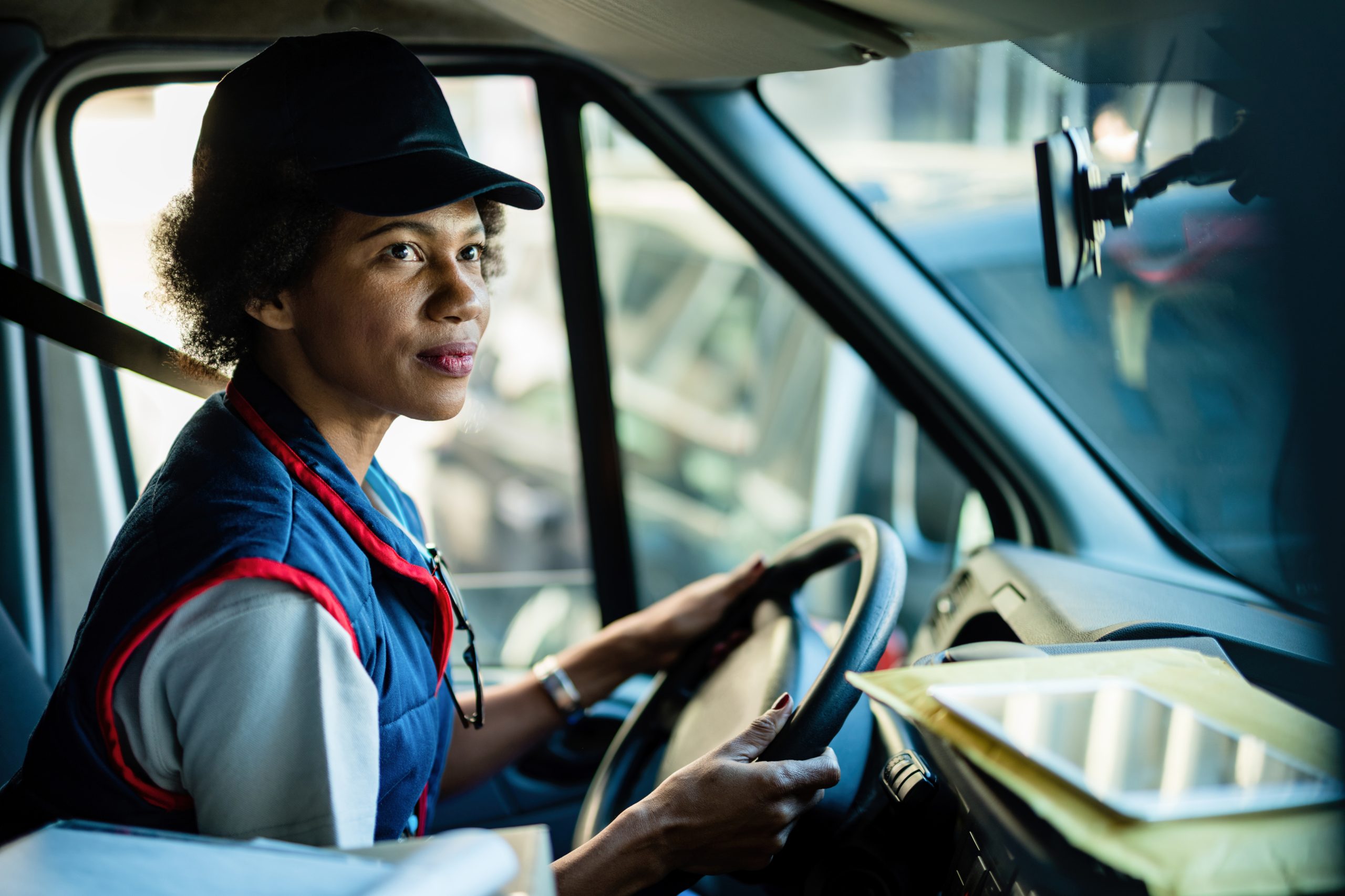 african american female courier driving delivery van city 1 scaled