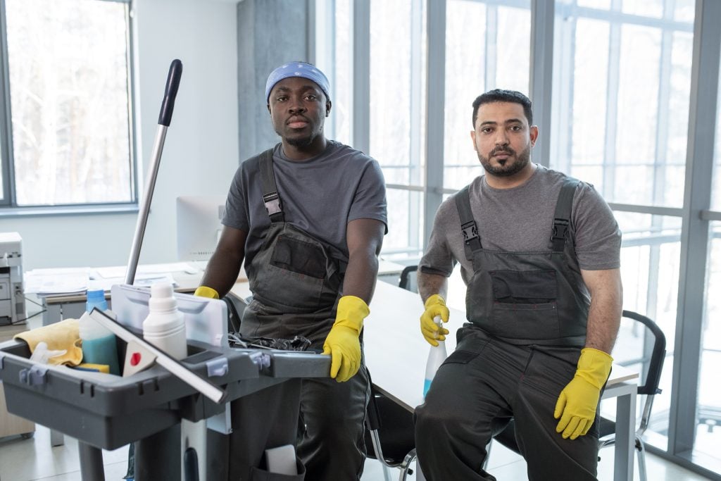 medium shot workers with cleaning cart 1
